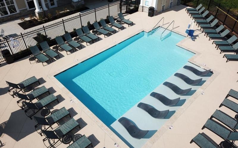 a pool surrounded by lounge chairs