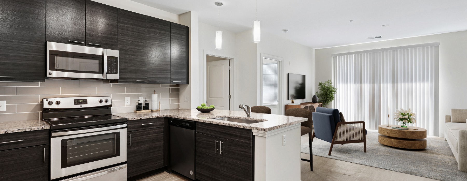 a kitchen leading into a living area with a large window