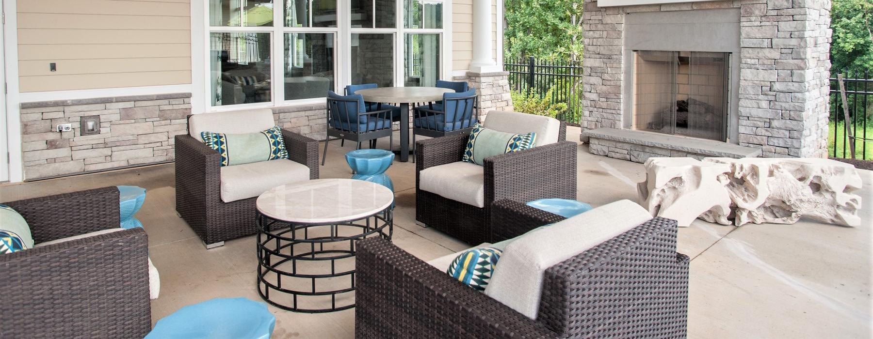 a covered patio with a fireplace and tv