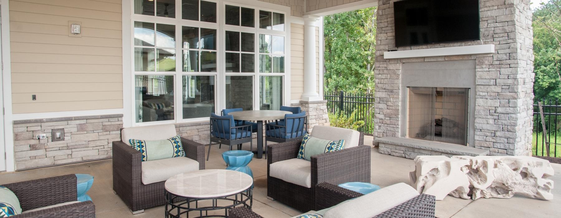 a patio with seating and a fireplace