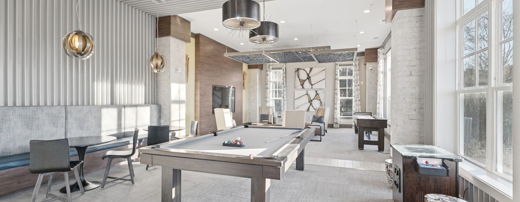 a lounge room with a pool table and chairs