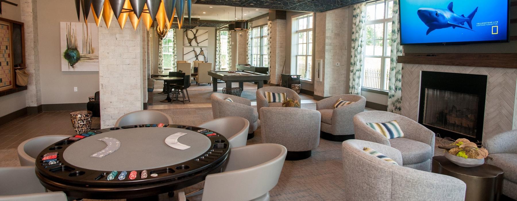 a lounge room with a card table and chairs